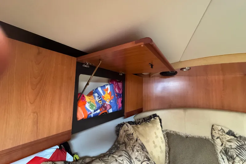Slide: The Image of Interior of 2008 Luhrs 41 Open boat with open wooden cabinet and colorful items inside. - 65