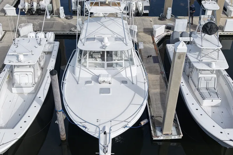 Slide: The Image of 2008 Luhrs 41 Open yacht docked between two boats at a marina. - 102