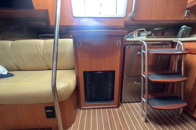 Slide: The Image of 2008 Luhrs 41 Open yacht interior with beige seating, wooden cabinetry, and compact stairs. - 76