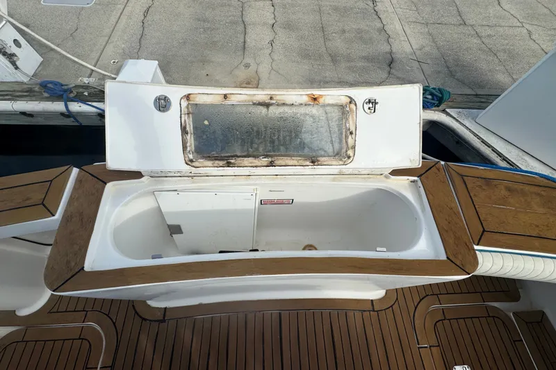 Slide: The Image of 2008 Luhrs 41 Open boat deck with storage compartment and wooden trim. - 16