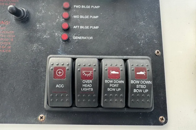 Slide: The Image of Control panel of a 2008 Luhrs 41 Open boat with labeled switches and indicators. - 52