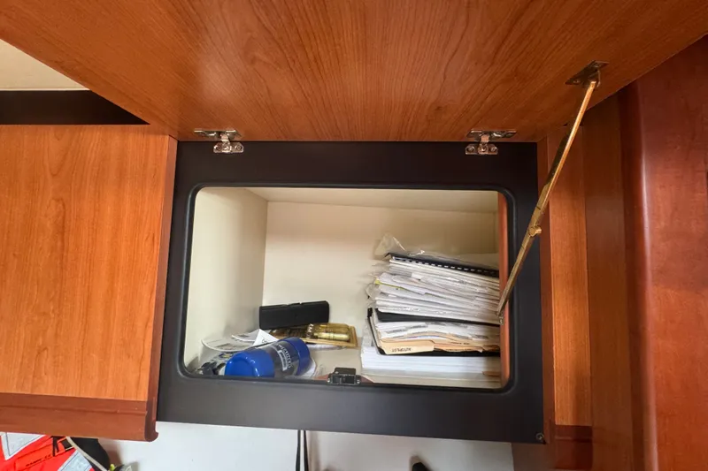 Slide: The Image of Open wooden cabinet on 2008 Luhrs 41 Open boat, storing documents and items. - 67