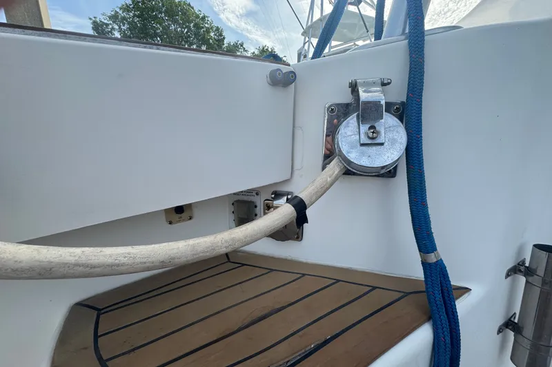 Slide: The Image of 2008 Luhrs 41 Open boat deck with hose and blue rope. - 24