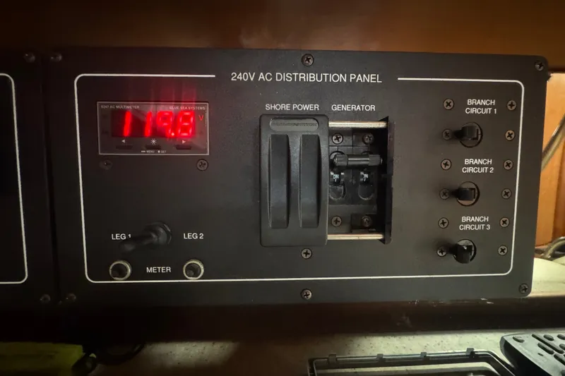 Slide: The Image of 2008 Luhrs 41 Open 240V AC distribution panel with voltage display and circuit switches. - 81