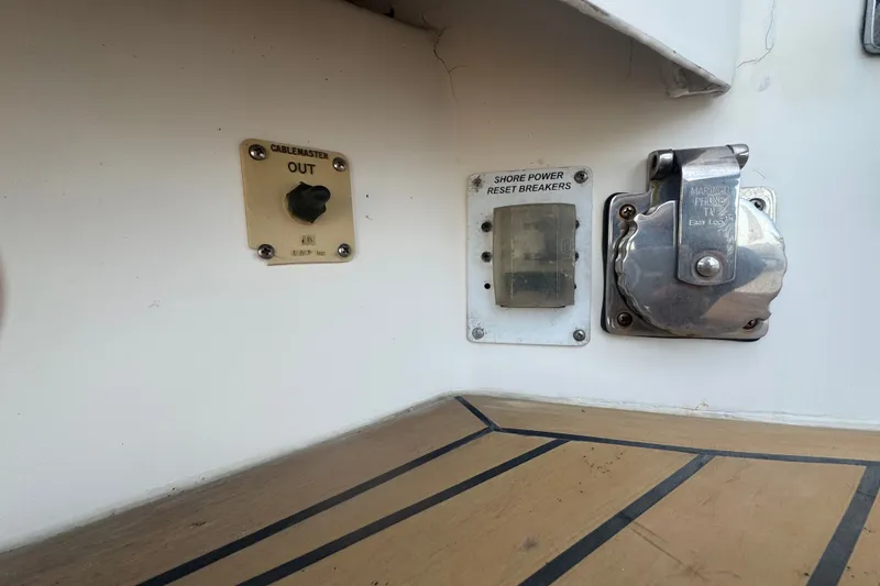 Slide: The Image of 2008 Luhrs 41 Open boat electrical panel with shore power and cablemaster controls. - 26