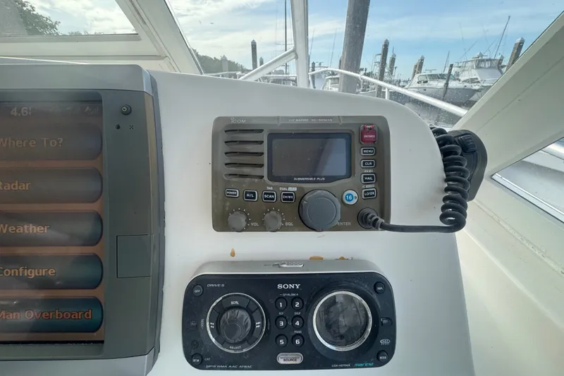 Slide: The Image of Control panel of a 2008 Luhrs 41 Open boat with navigation and communication equipment. - 55