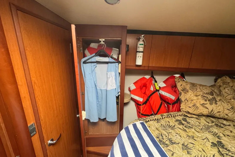 Slide: The Image of Interior of 2008 Luhrs 41 Open boat with closet, life jackets, and bed. - 70