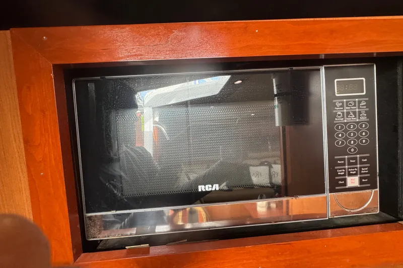Slide: The Image of RCA microwave in wooden cabinet on 2008 Luhrs 41 Open boat. - 92
