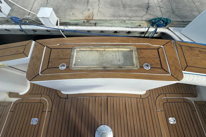 Slide: The Image of 2008 Luhrs 41 Open boat deck with teak flooring and storage compartment. - 15