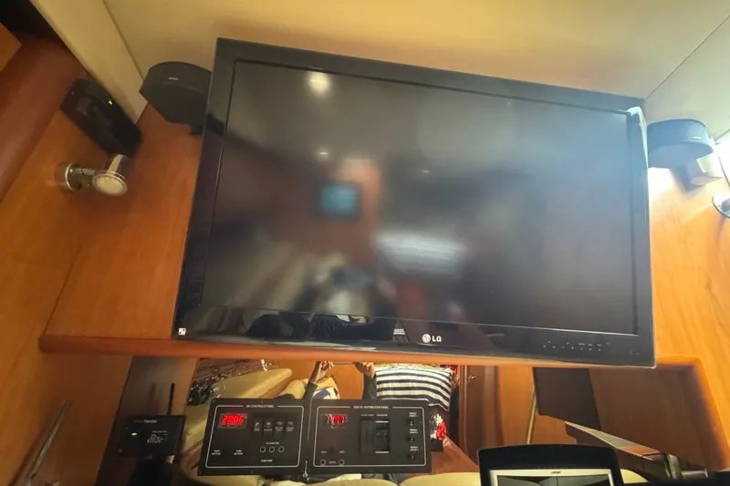 Slide: The Image of LG TV and control panels inside 2008 Luhrs 41 Open boat cabin. - 78