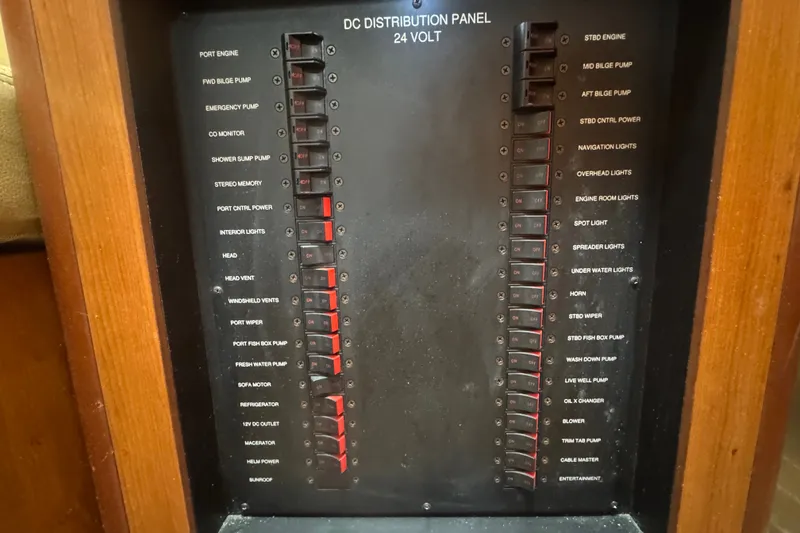 Slide: The Image of DC distribution panel on a 2008 Luhrs 41 Open boat, featuring various switches. - 75