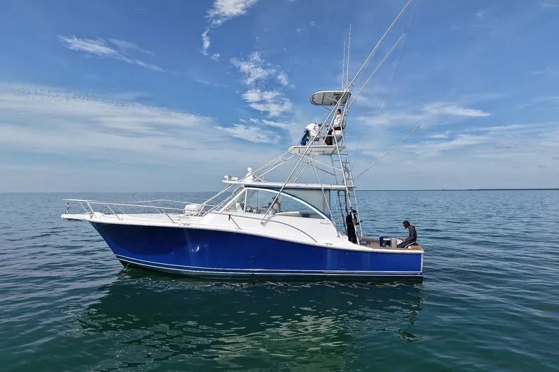 The Image of 2008 Luhrs 41 Open boat on calm ocean waters under a clear blue sky. - 0