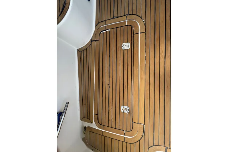 Slide: The Image of Teak deck of 2008 Luhrs 41 Open boat, featuring sleek wood finish and hatch. - 17