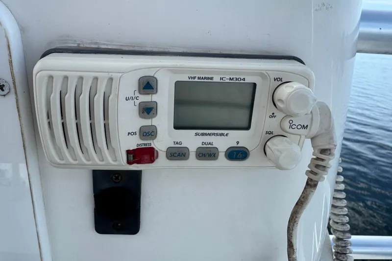 Slide: The Image of VHF marine radio on 2008 Luhrs 41 Open boat, model IC-M304, near water. - 53