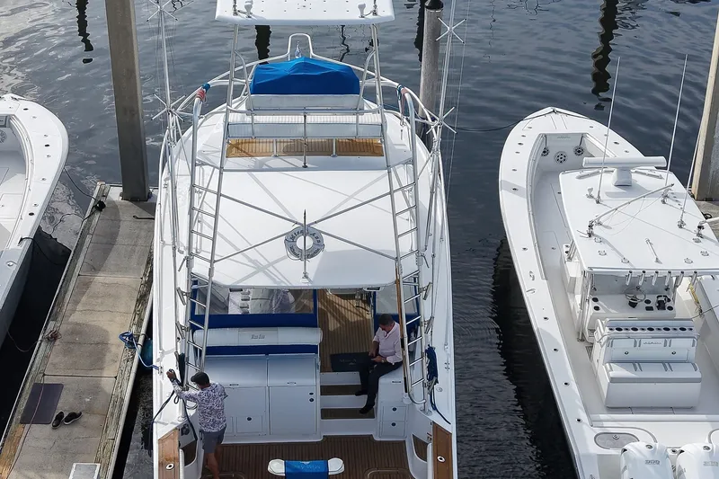 Slide: The Image of 2008 Luhrs 41 Open yacht docked between two boats at a marina. - 100