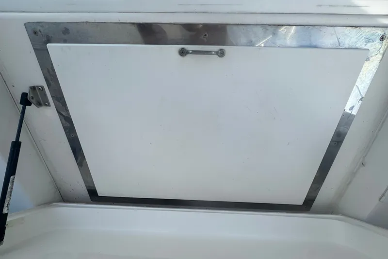 Slide: The Image of Hatch door on a 2008 Luhrs 41 Open boat, featuring metal trim and hydraulic support. - 28