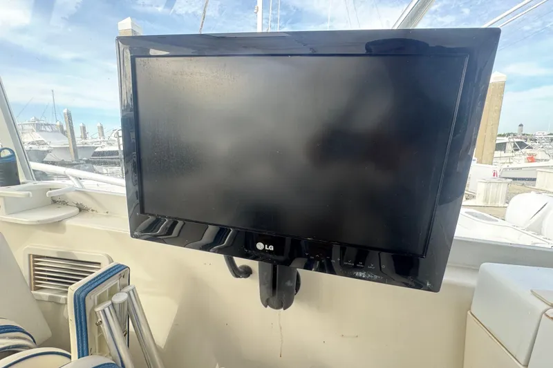 Slide: The Image of LG TV mounted on a 2008 Luhrs 41 Open boat, docked at a marina. - 58