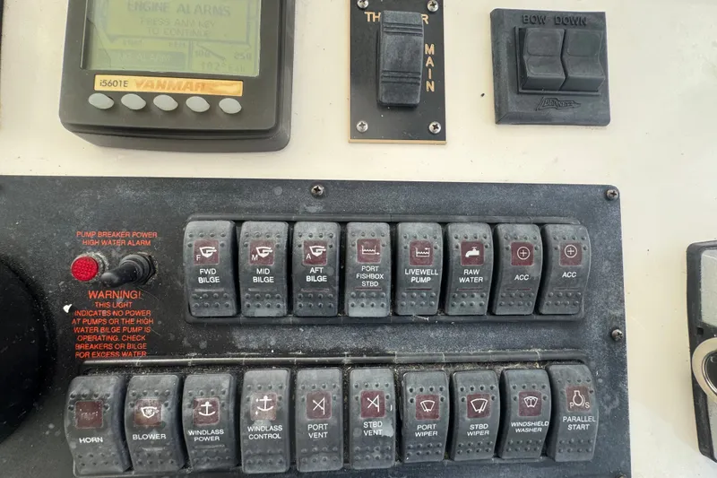 Slide: The Image of Control panel of a 2008 Luhrs 41 Open boat with various switches and indicators. - 56
