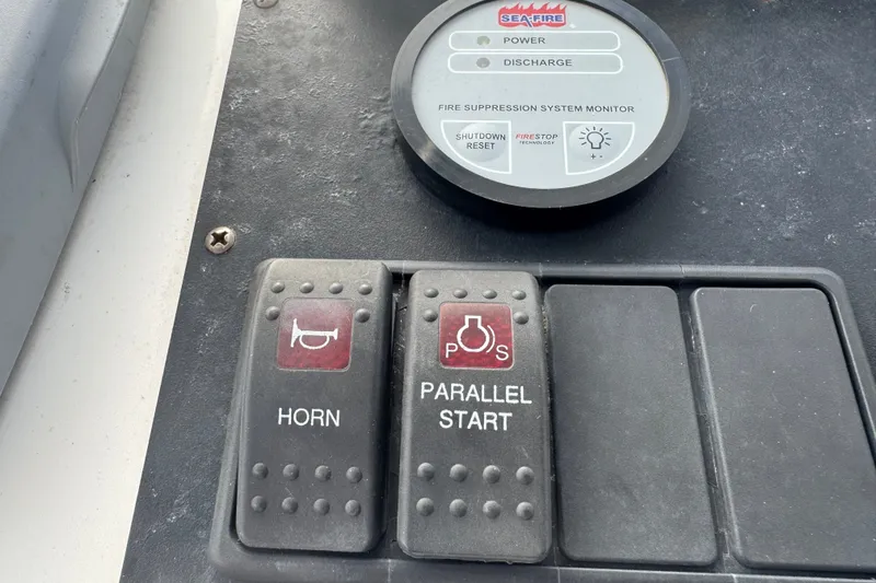 Slide: The Image of Control panel of a 2008 Luhrs 41 Open boat with horn and parallel start buttons. - 51