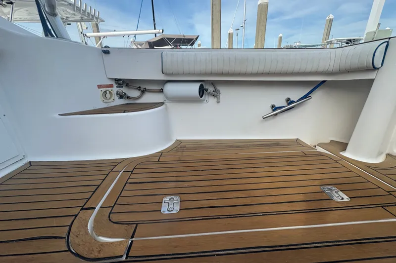 Slide: The Image of 2008 Luhrs 41 Open boat deck with teak flooring and white seating. - 22