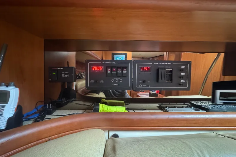 Slide: The Image of Control panel inside 2008 Luhrs 41 Open boat, featuring various electronic displays and switches. - 79