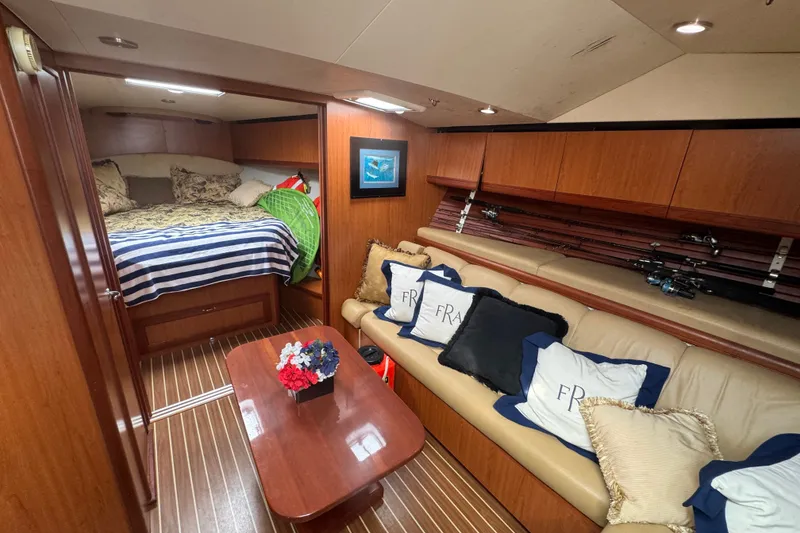 Slide: The Image of 2008 Luhrs 41 Open yacht interior with cozy cabin, striped bedding, and fishing rods. - 63
