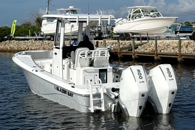 Slide: The Image of 2026 Blazer Bay Makaira 2800 boat with dual 300 V8 engines on water. - 7