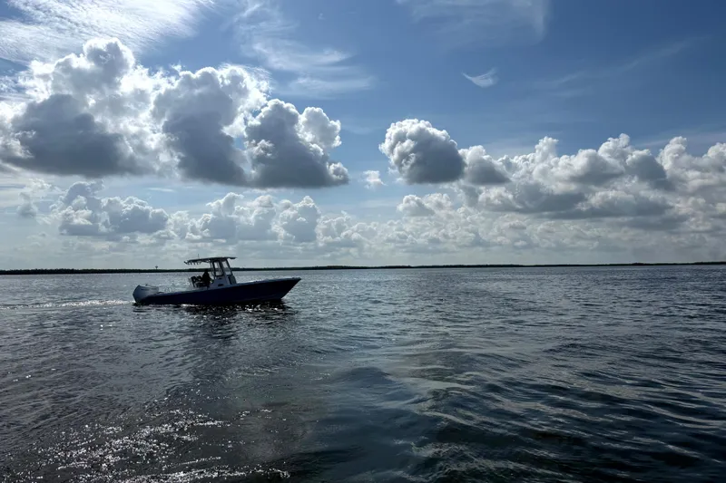 Slide: The Image of 2026 Blazer Bay Makaira 2800 boat cruising under cloudy sky on open water. - 11