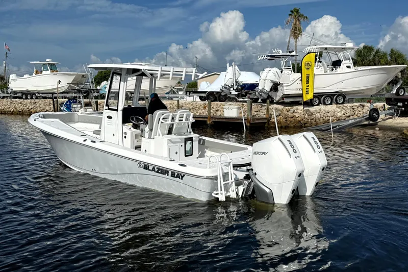 Slide: The Image of 2026 Blazer Bay Makaira 2800 boat with dual Mercury engines docked at marina. - 8
