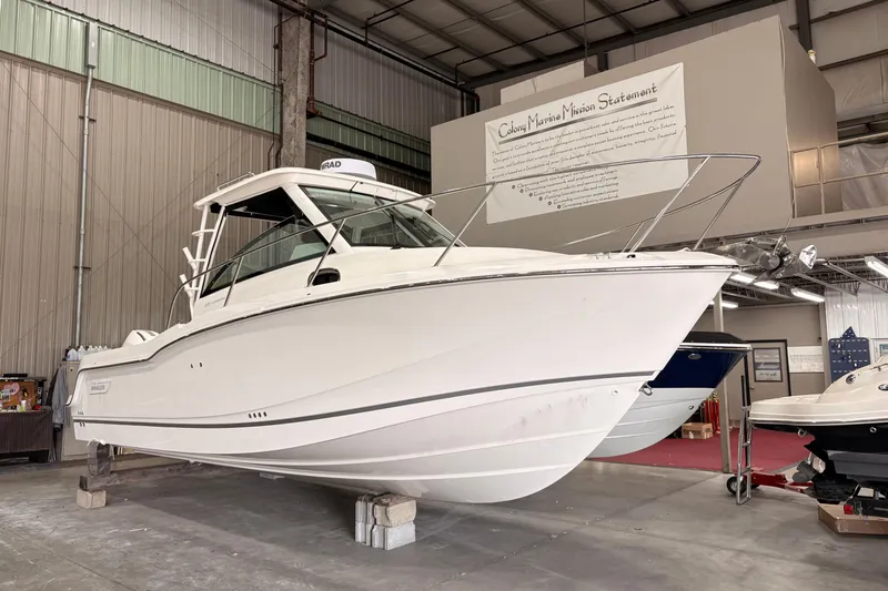 The Image of 2026 Boston Whaler 285 Conquest boat displayed indoors, showcasing sleek design and craftsmanship. - 1