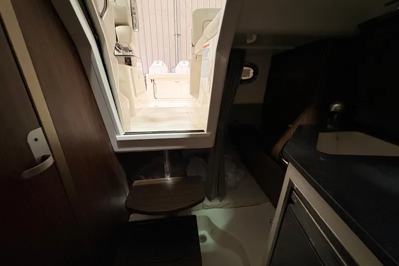 Slide: The Image of Interior view of 2026 Boston Whaler 285 Conquest cabin, featuring seating and kitchenette. - 20