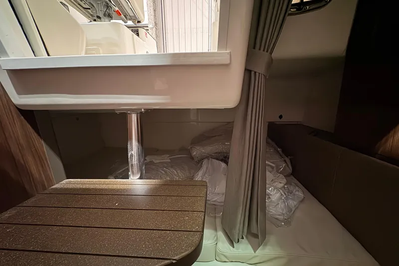 Slide: The Image of Interior cabin of 2026 Boston Whaler 285 Conquest with seating and curtain. - 21