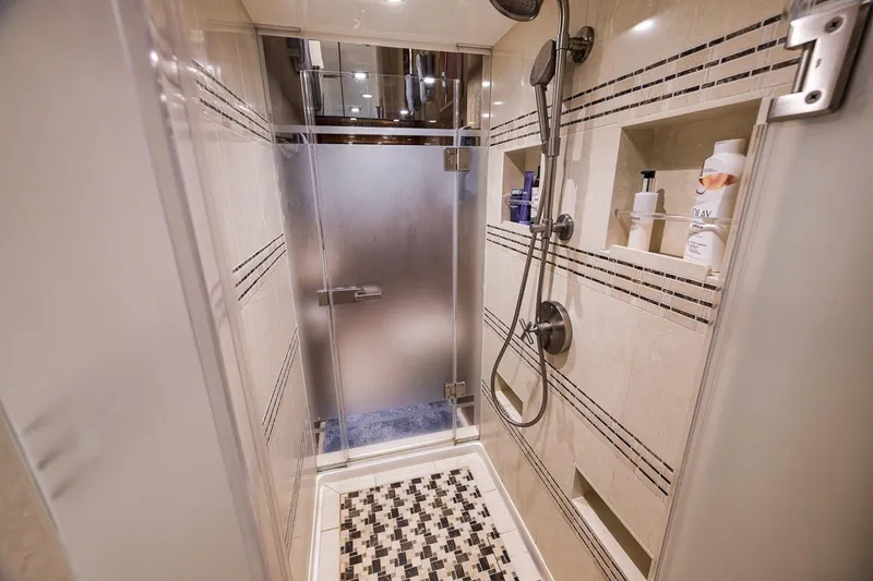 Slide: The Image of Luxurious shower in 2018 Viking 92 Sky Bridge yacht with modern fixtures and tiled design. - 108