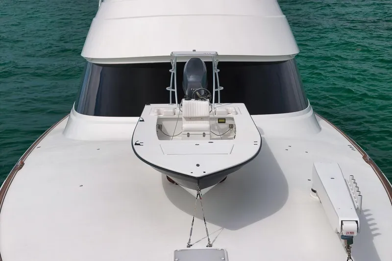 Slide: The Image of 2018 Viking 92 Sky Bridge yacht on turquoise water, showcasing sleek design and spacious deck. - 11