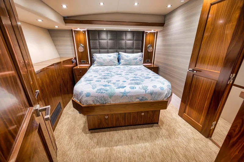 Slide: The Image of Luxurious bedroom interior of 2018 Viking 92 Sky Bridge yacht with elegant wood finishes. - 111