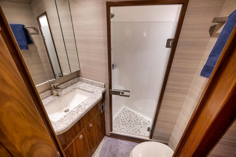 Slide: The Image of Luxurious bathroom in 2018 Viking 92 Sky Bridge yacht with modern fixtures and elegant design. - 115