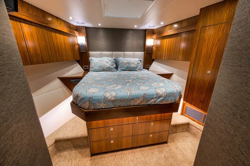 Slide: The Image of Luxurious bedroom interior of 2018 Viking 92 Sky Bridge yacht with elegant wood finish. - 116
