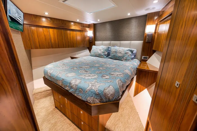 Slide: The Image of Luxurious bedroom interior of 2018 Viking 92 Sky Bridge yacht with elegant wood finishes. - 117
