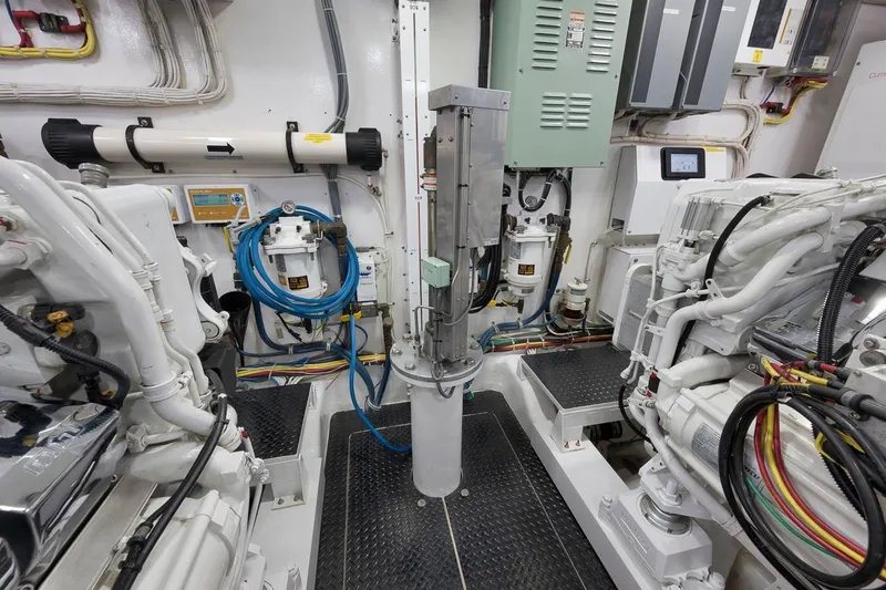Slide: The Image of Engine room of 2018 Viking 92 Sky Bridge yacht, showcasing machinery and wiring. - 128