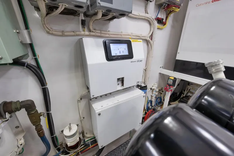 Slide: The Image of Engine room of 2018 Viking 92 Sky Bridge yacht with control panel and wiring. - 131