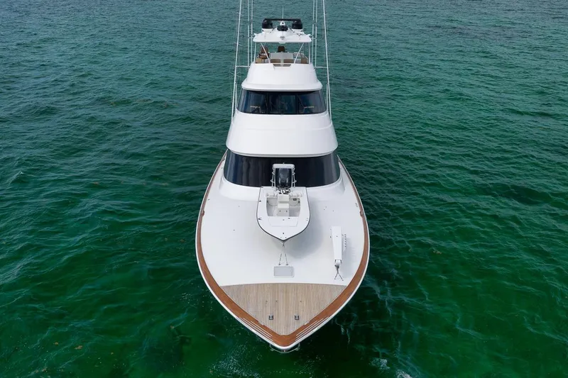 Slide: The Image of 2018 Viking 92 Sky Bridge yacht on clear ocean waters, aerial view. - 16