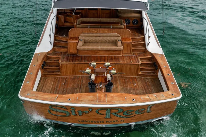 Slide: The Image of 2018 Viking 92 Sky Bridge yacht with wooden deck and fishing rods in ocean. - 20