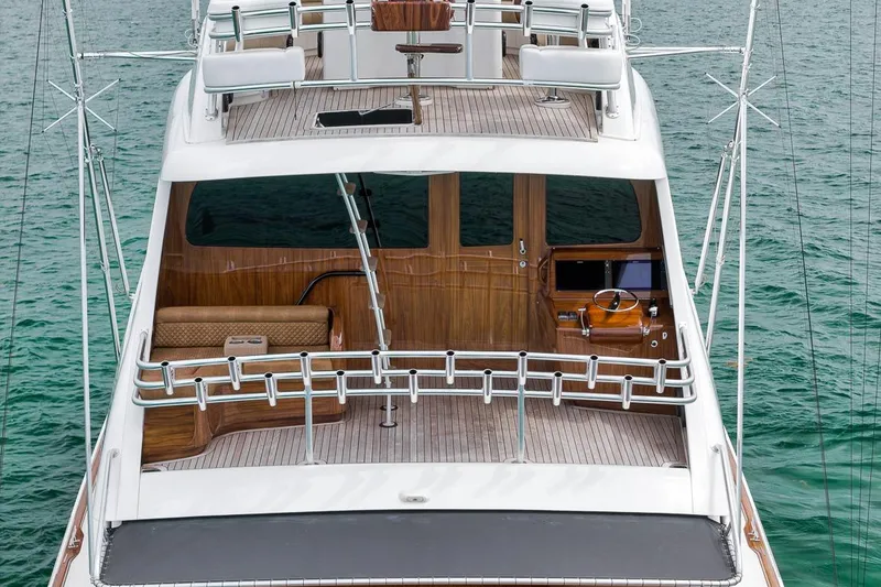 Slide: The Image of 2018 Viking 92 Sky Bridge yacht with elegant wooden interior on calm water. - 23