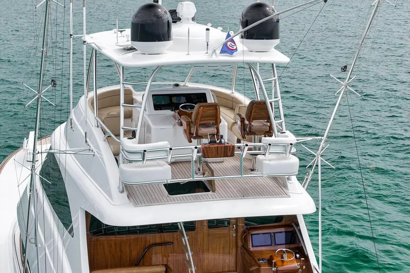 Slide: The Image of 2018 Viking 92 Sky Bridge yacht with luxurious upper deck and helm, cruising on the ocean. - 24