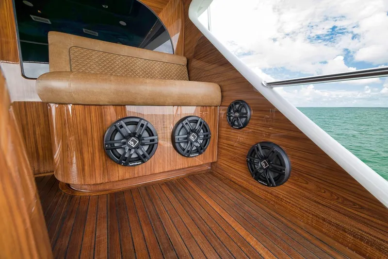 Slide: The Image of Luxurious 2018 Viking 92 Sky Bridge yacht interior with wood finish and premium speakers. - 28