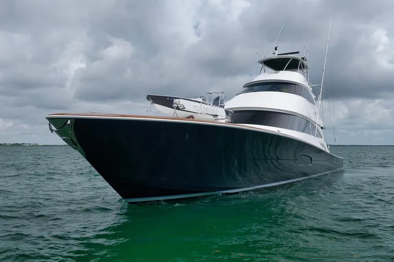 Slide: The Image of 2018 Viking 92 Sky Bridge yacht on open water under cloudy skies. - 3