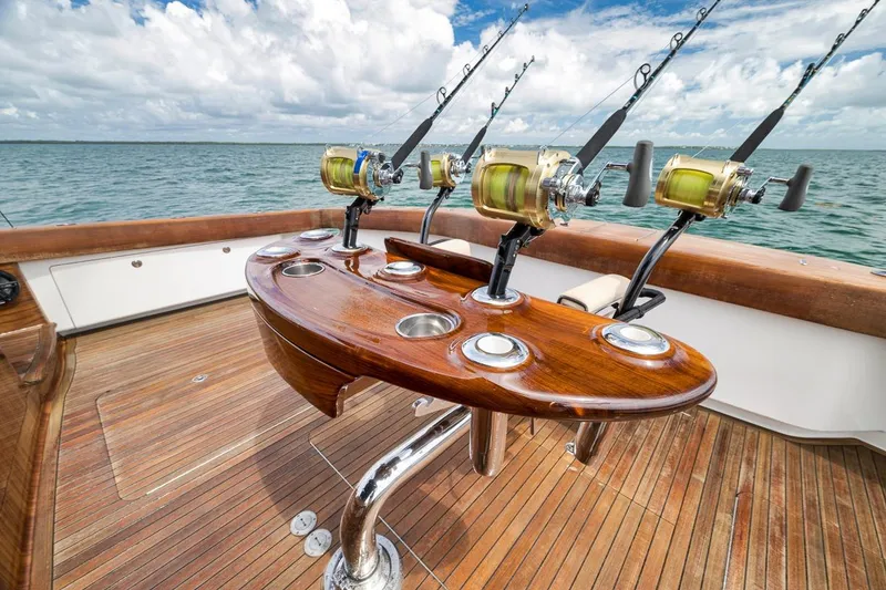 Slide: The Image of Fishing setup on 2018 Viking 92 Sky Bridge yacht, featuring wooden deck and ocean view. - 37