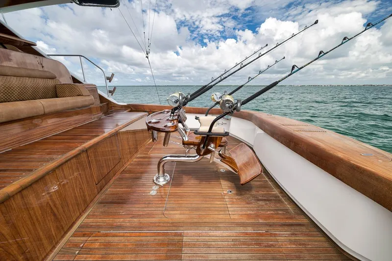 Slide: The Image of 2018 Viking 92 Sky Bridge yacht with fishing rods on deck, set against ocean backdrop. - 39