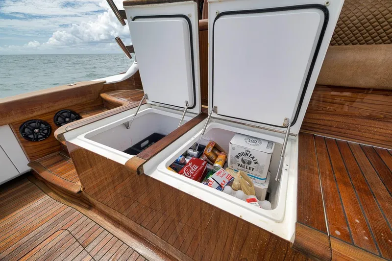 Slide: The Image of Open cooler on 2018 Viking 92 Sky Bridge yacht deck, stocked with drinks and snacks. - 46