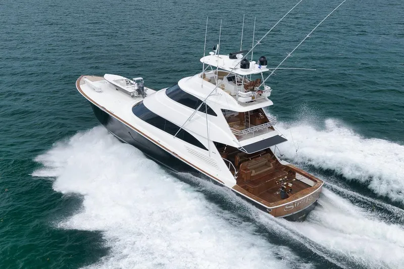 Slide: The Image of 2018 Viking 92 Sky Bridge yacht cruising on open water, showcasing sleek design and powerful performance. - 5